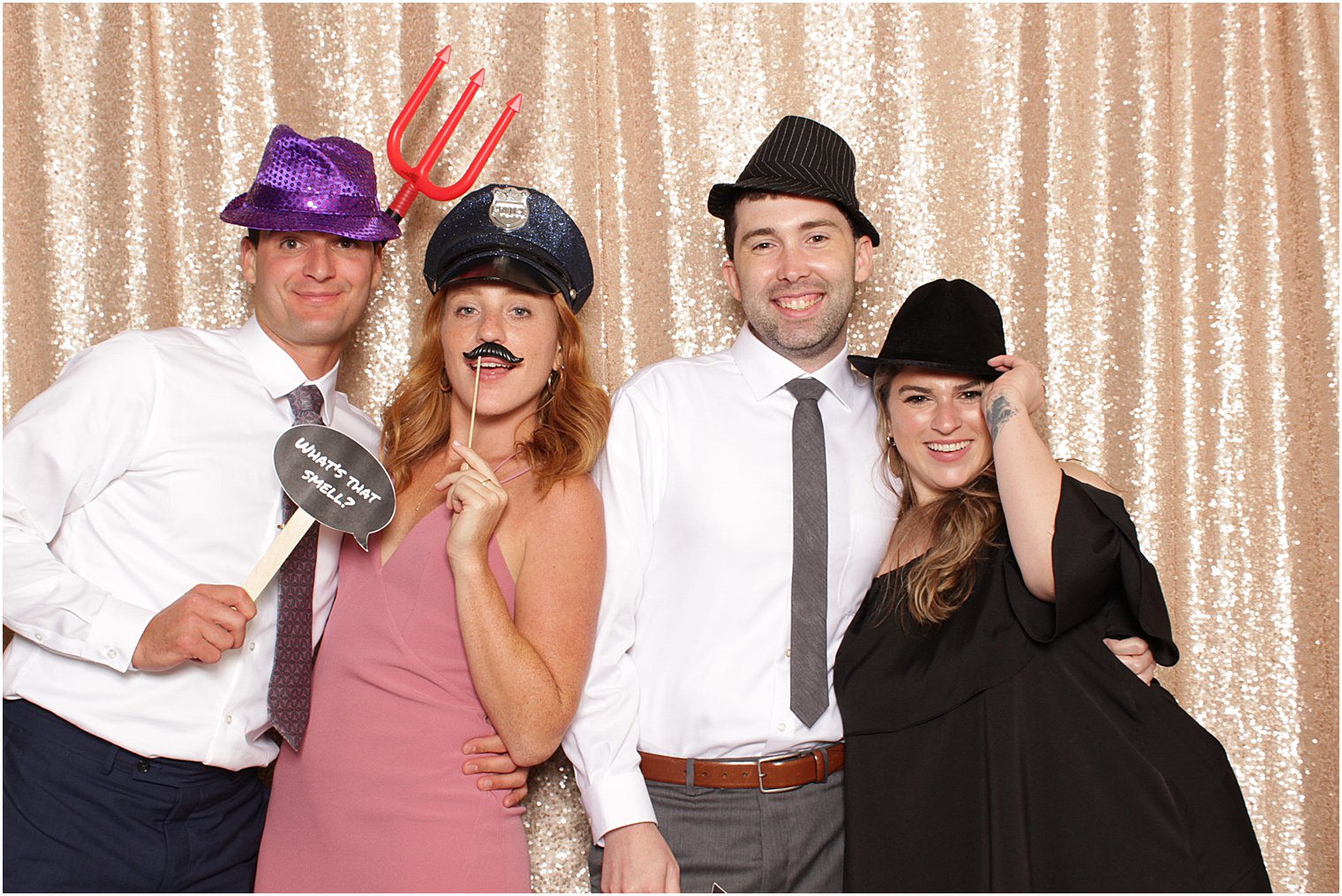 four friends pose together against rose gold backdrop at Indian Trail Club photo booth