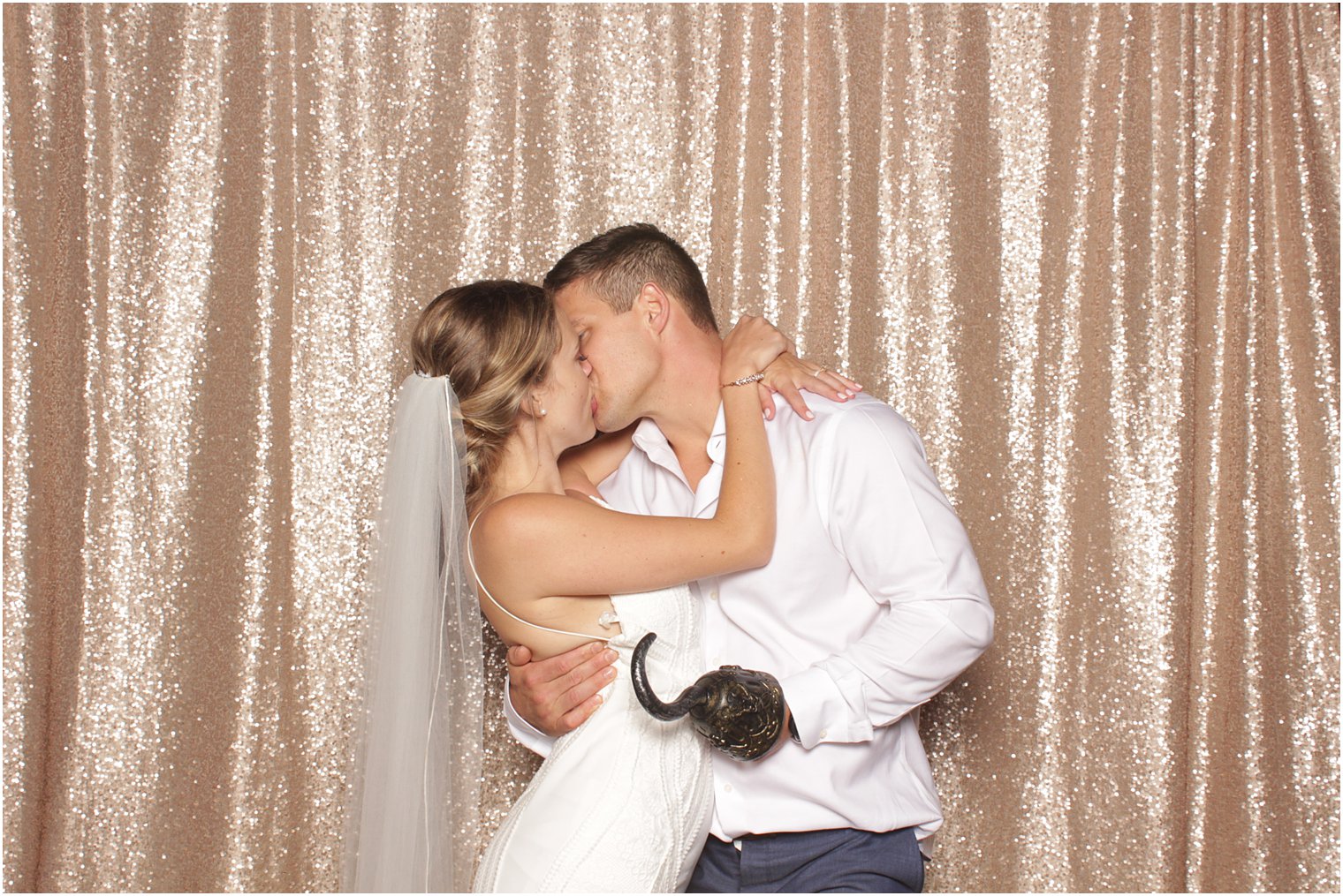 couple kisses during photo booth at Minerals Resort wedding reception