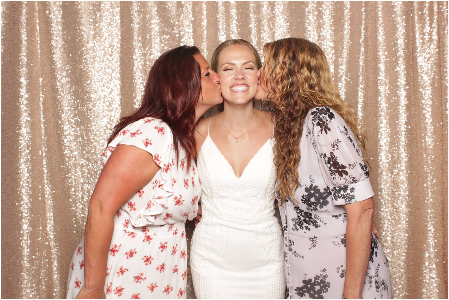 women kiss bride on the cheek during NJ wedding reception 