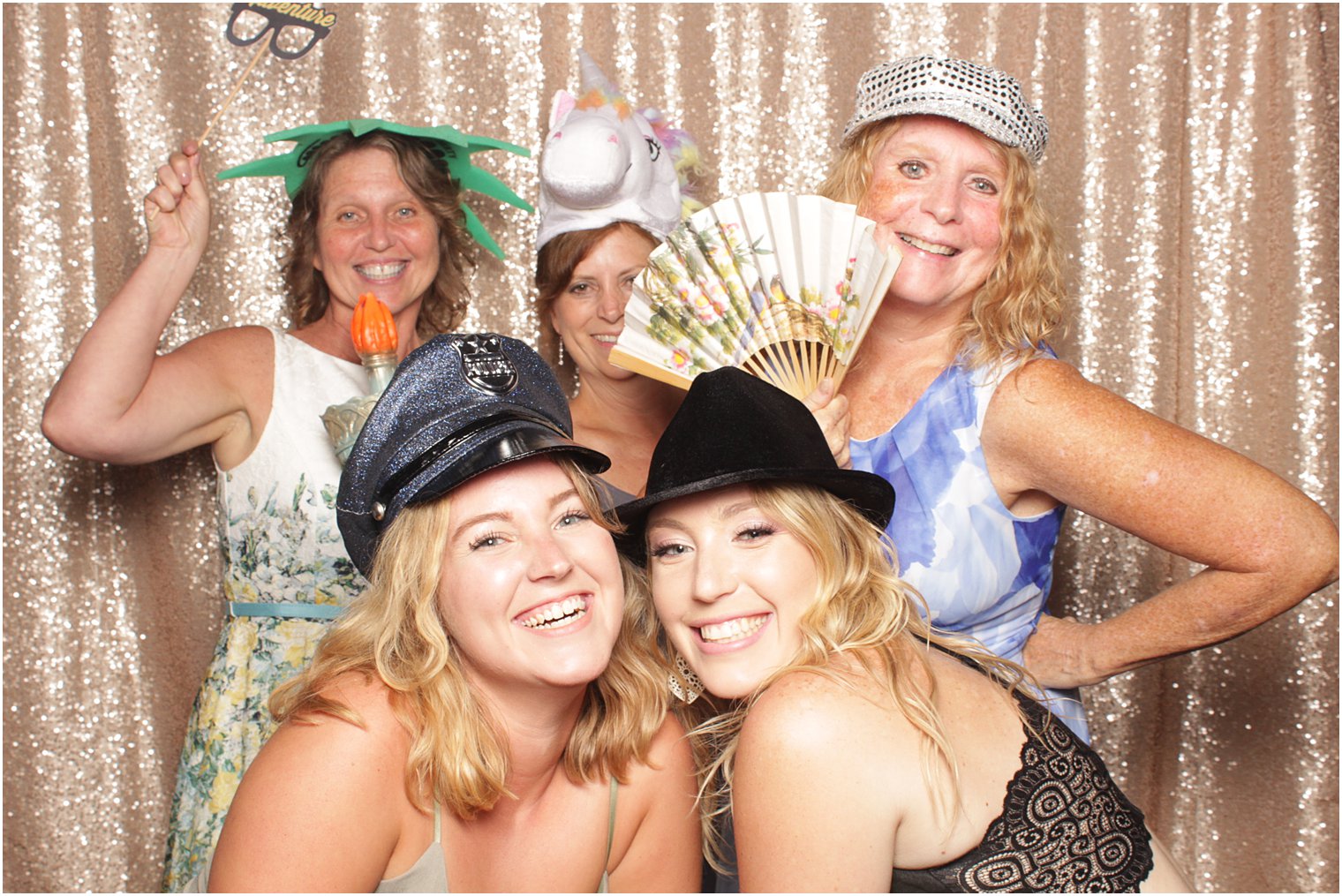 five women pose with props in Minerals Resort photo booth