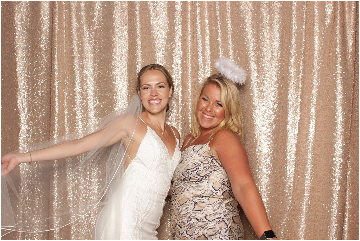 woman poses with bride during NJ photo booth