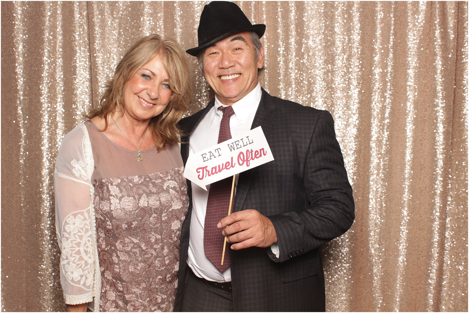 husband and wife pose with sign in photo booth at Minerals Resort