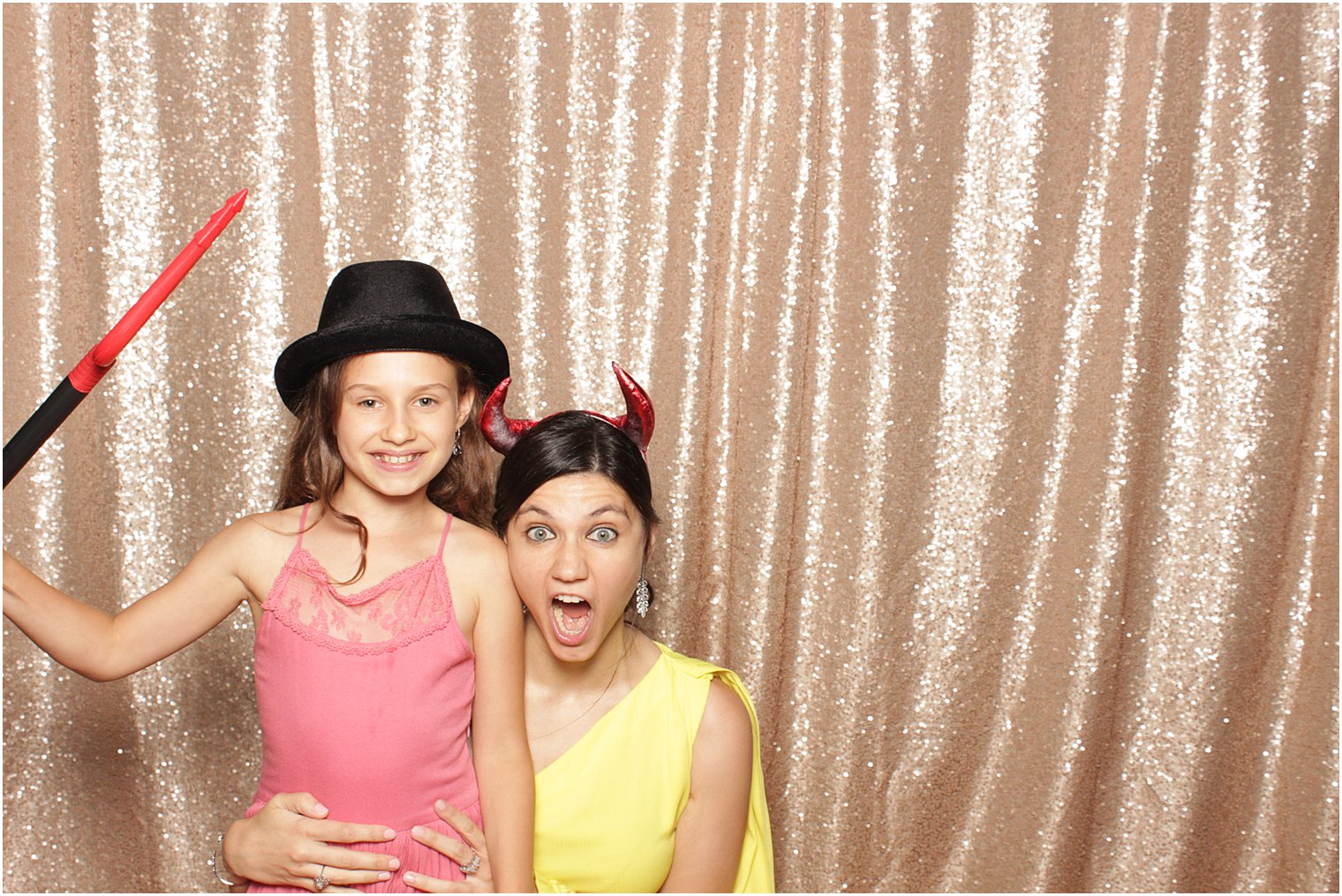 family plays during photo booth at The Manor wedding reception