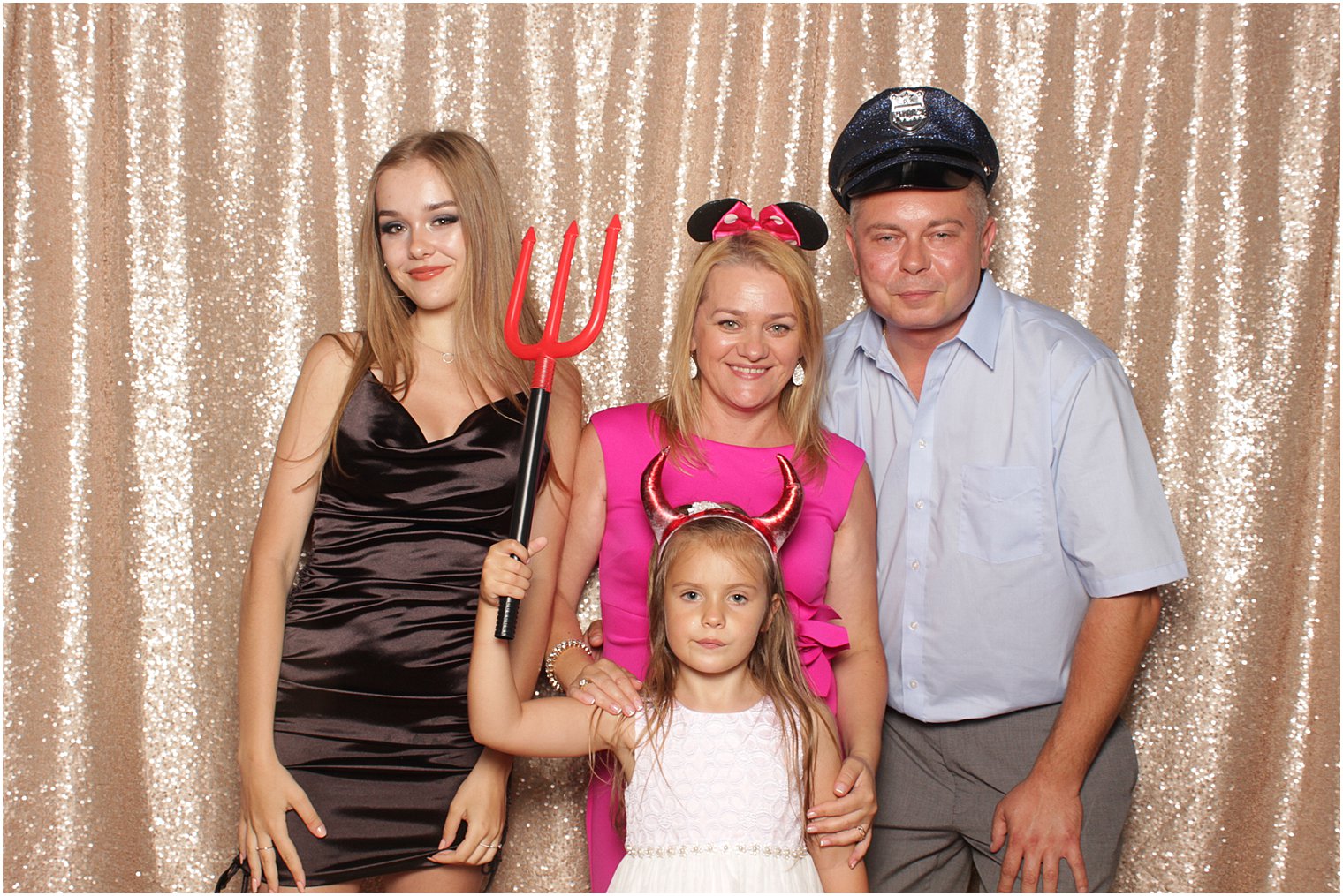 family of four poses during The Manor Photo Booth