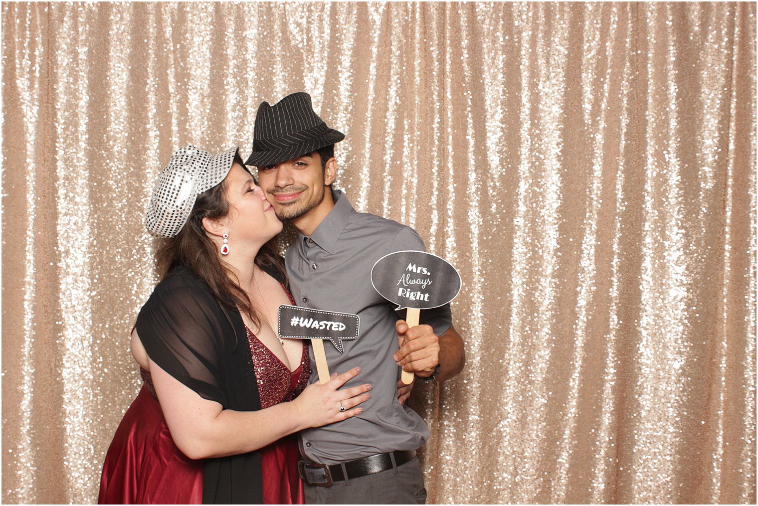 woman kisses man during The Manor Photo Booth