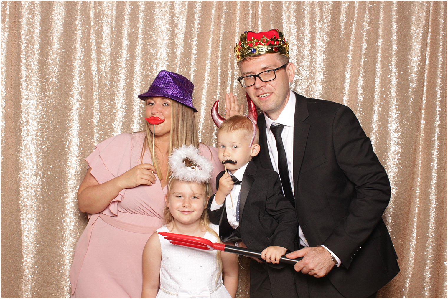family of four poses in photo booth