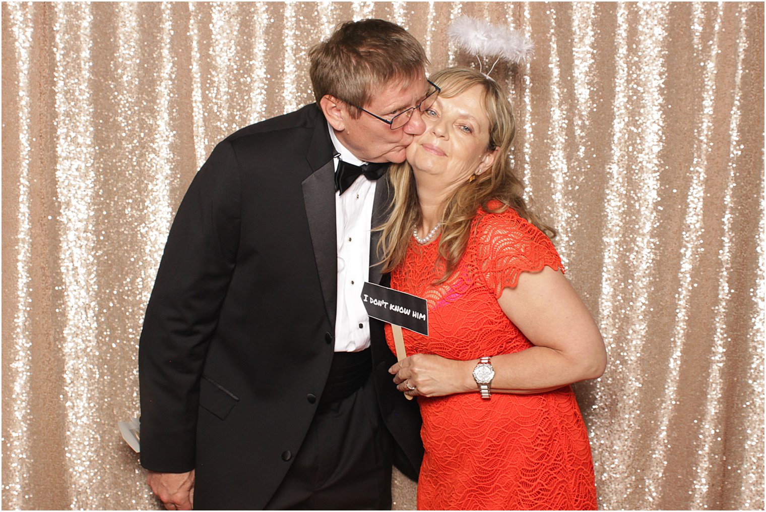 man kisses wife during The Manor Photo Booth