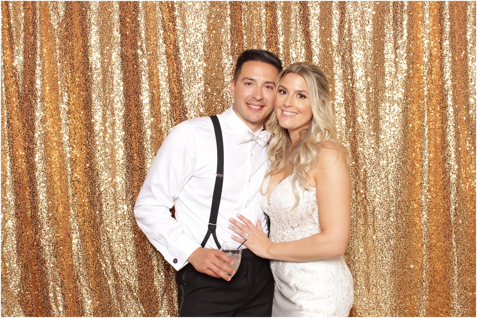 bride and groom hug in front of gold curtain during Valley Regency photo booth
