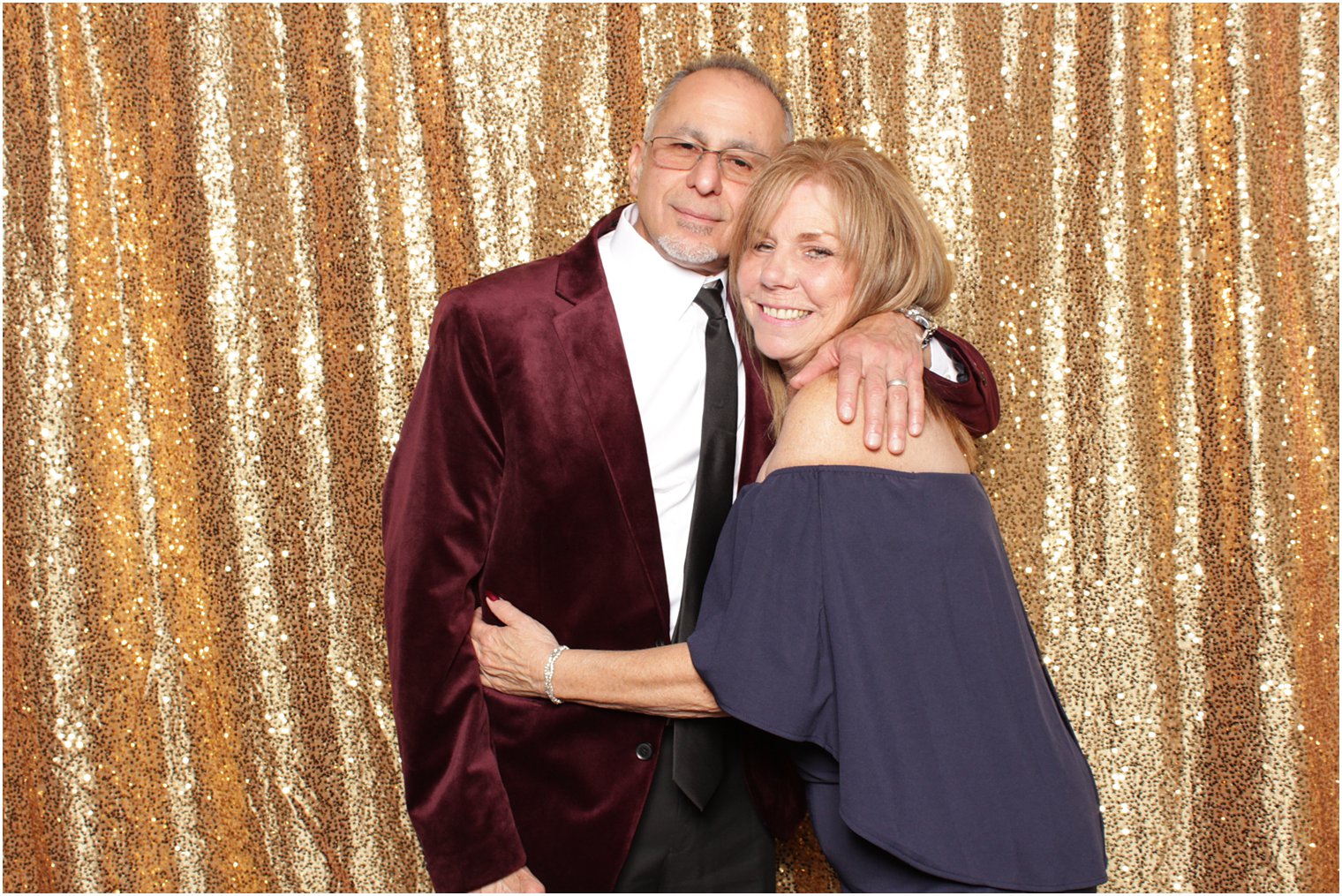 older couple hugs during reception photo booth