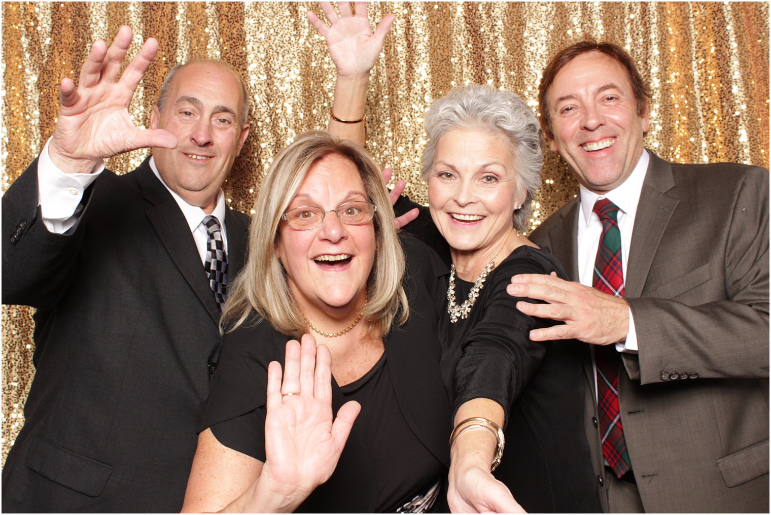 group of four adults pose during NJ wedding reception photo booth fun