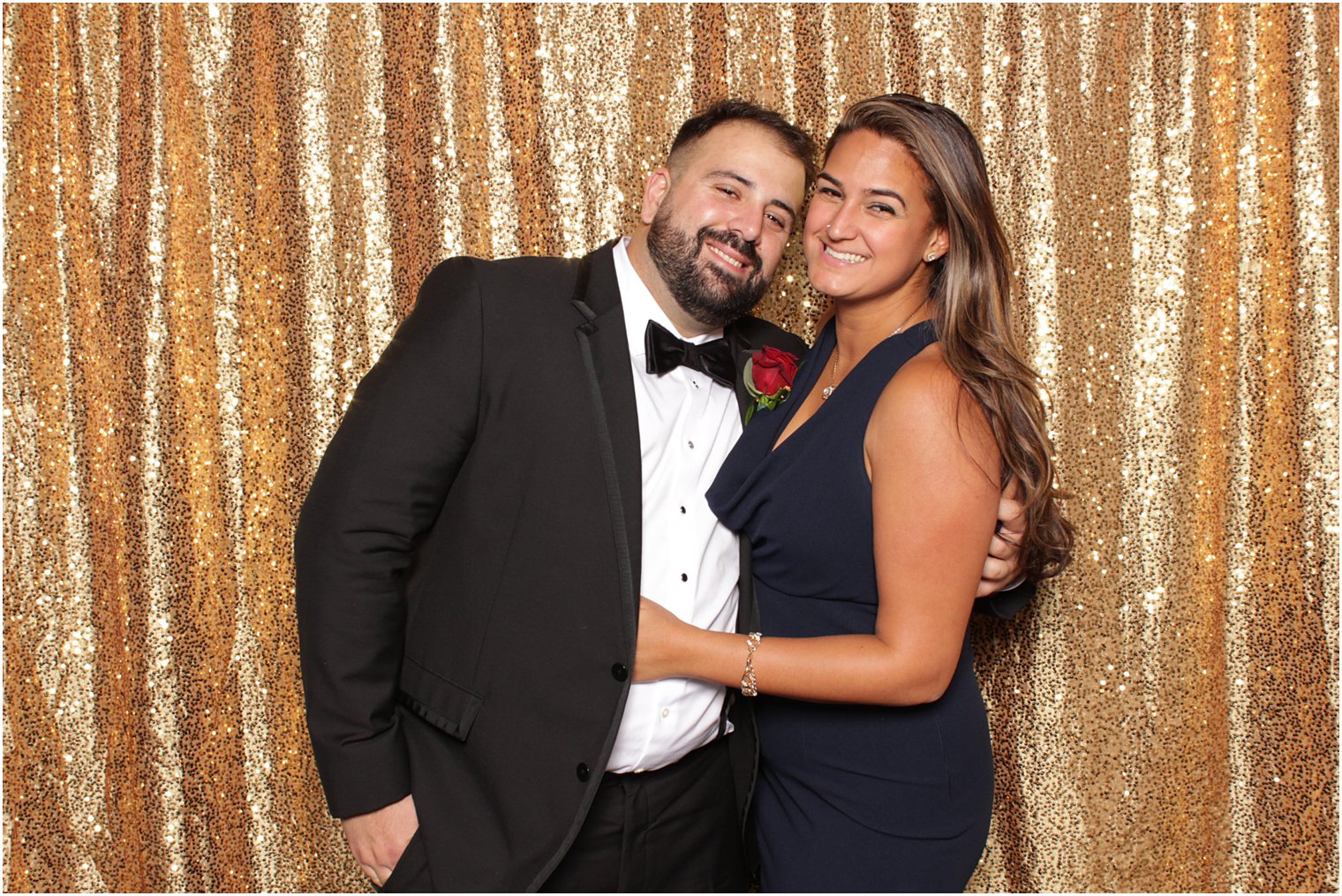 couple hugs by rose gold curtain during Valley Regency photo booth
