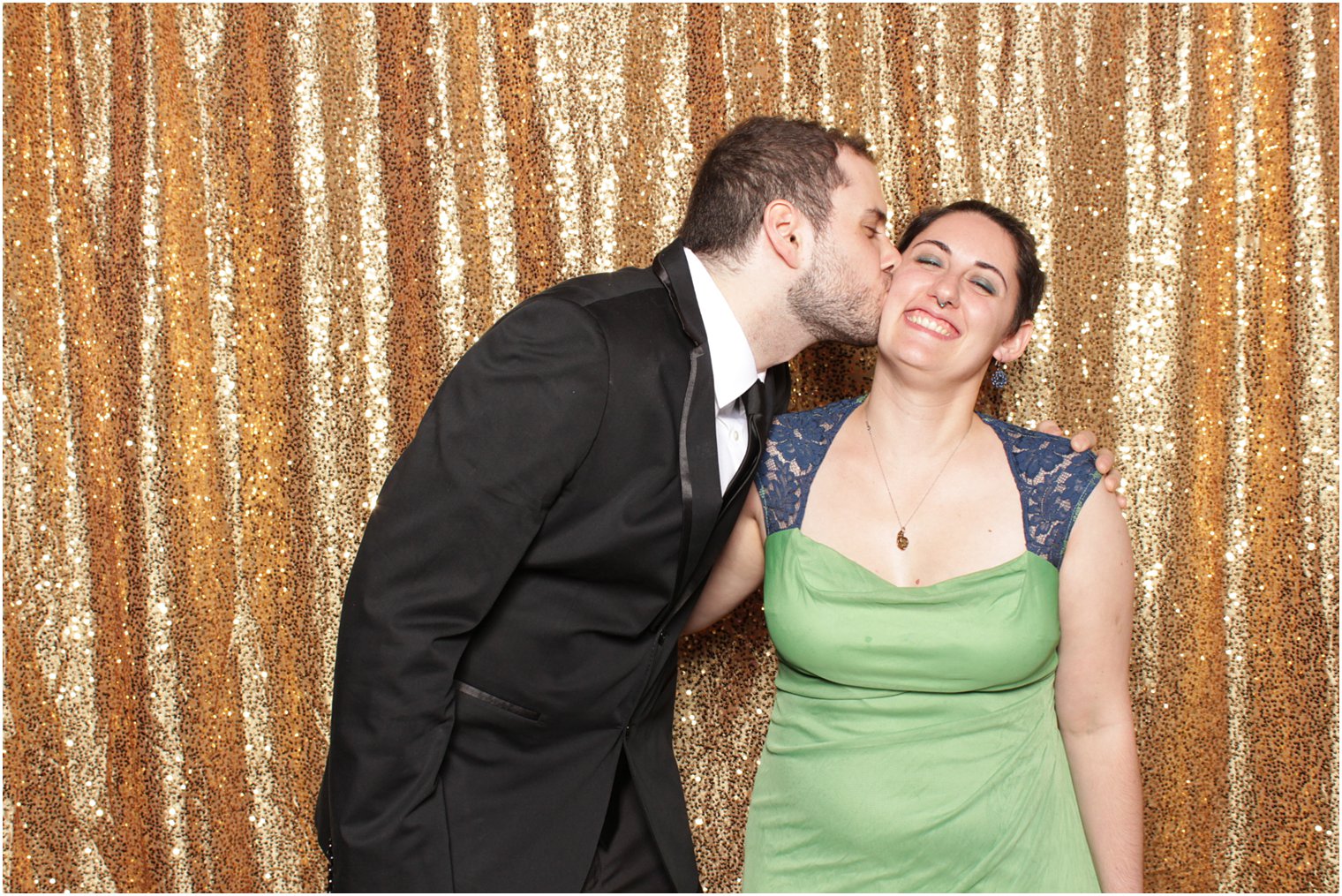 man kisses date during Valley Regency photo booth