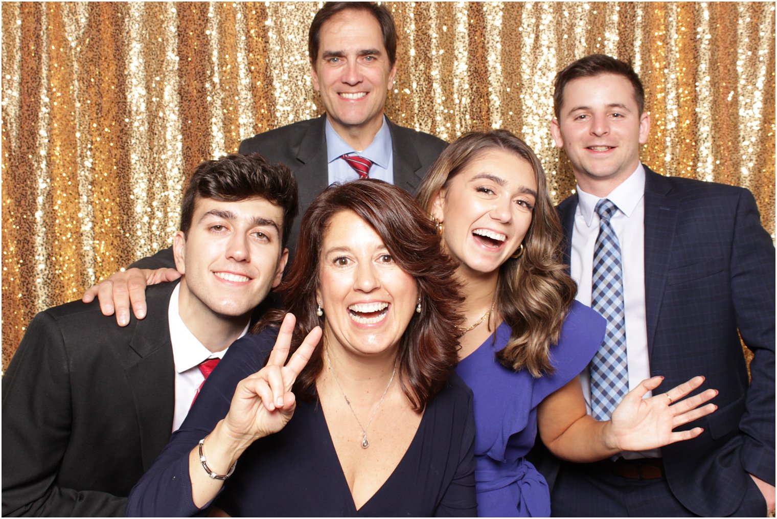 group of adults pose together during Valley Regency photo booth