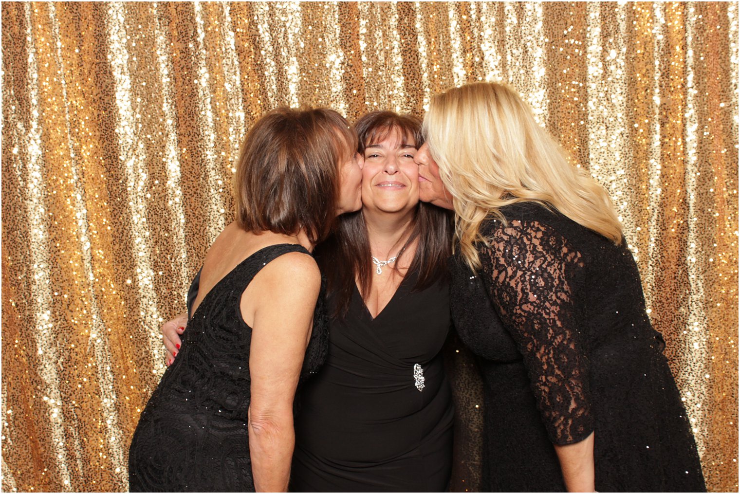 women kiss sister during photo booth 