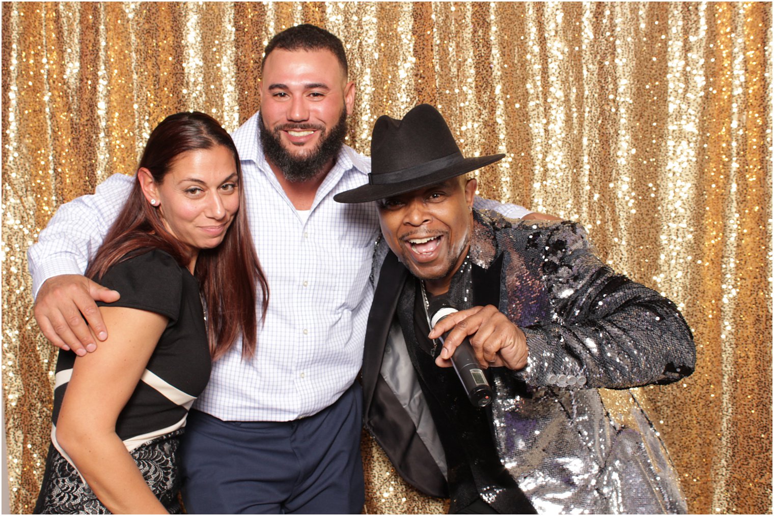 couple poses with DJ during reception 