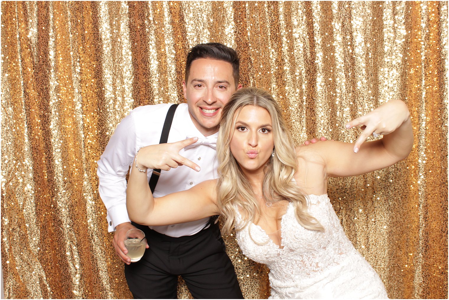 bride and groom pose in photo booth at Valley Regency reception