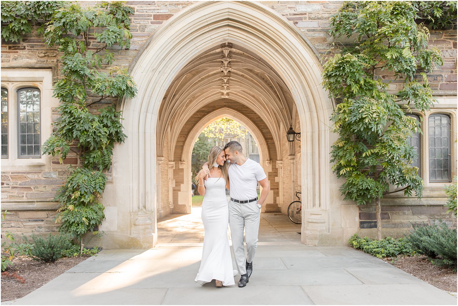 engagement photos at Princeton University for couple walking under arches