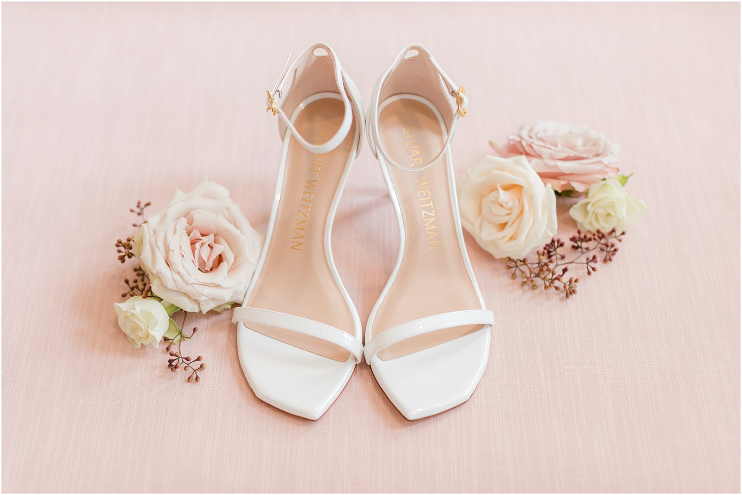 bride's white shoes and pastel roses before NJ wedding day