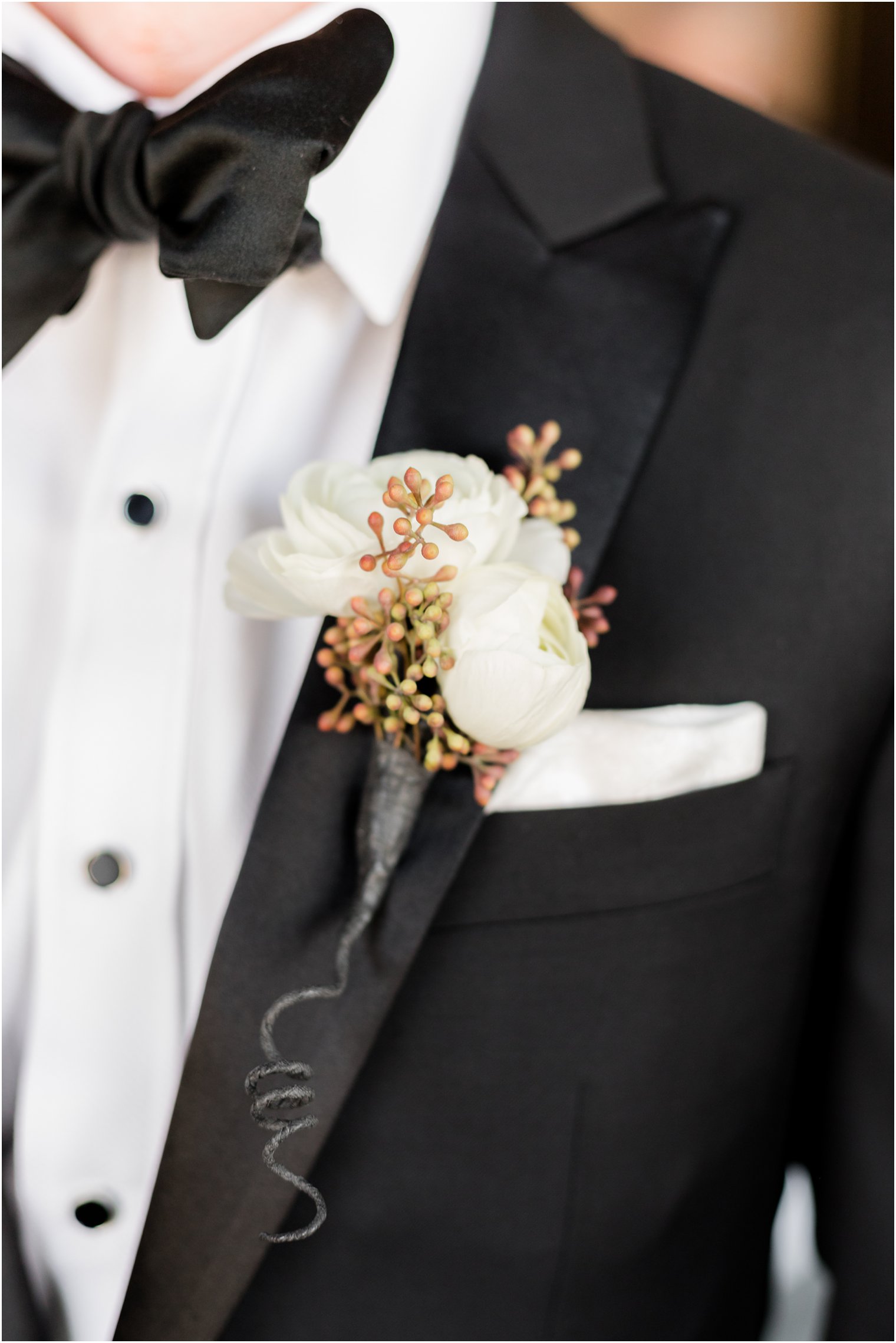 groom's white boutonniere for winter wedding day 