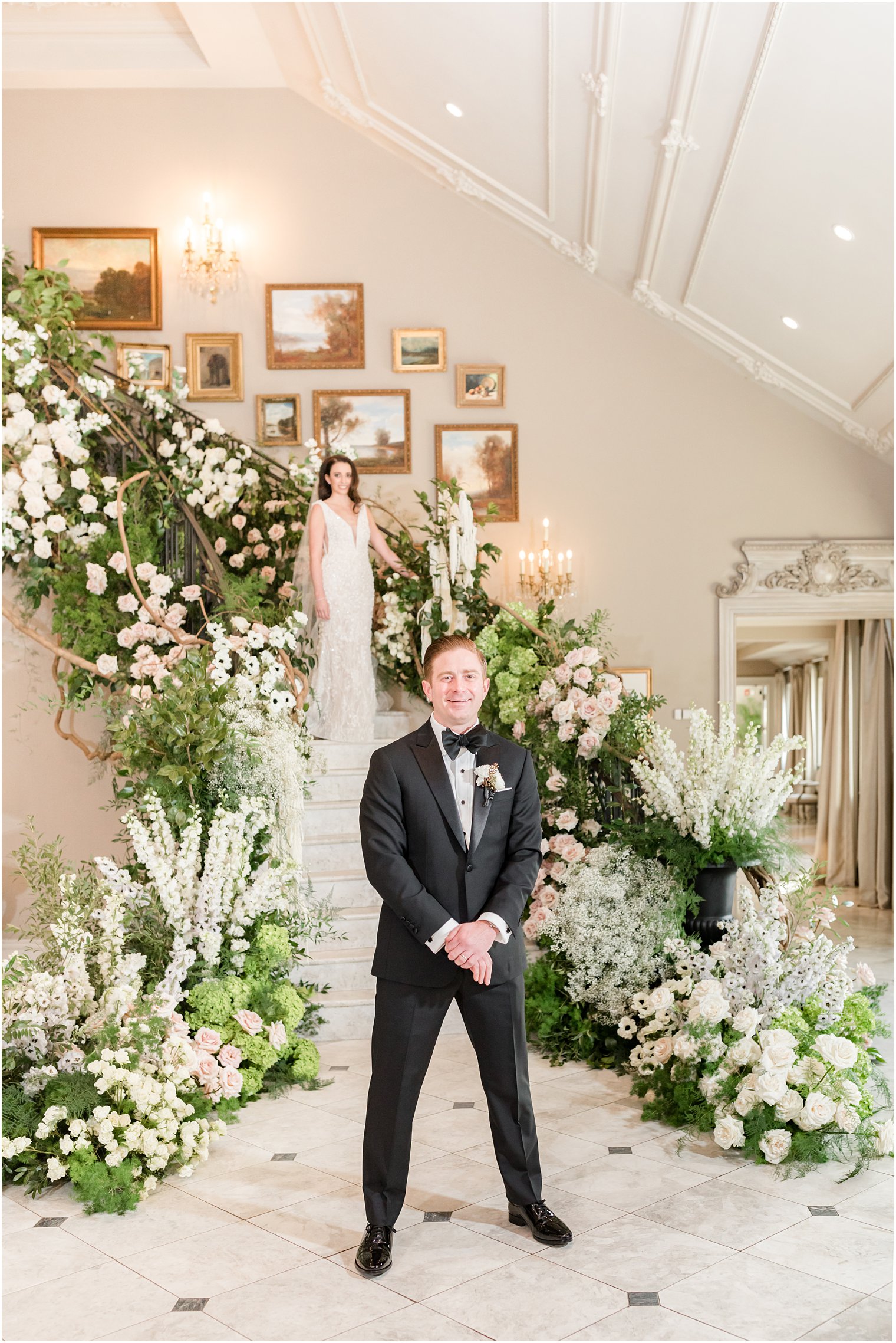 bride walks down steps at Park Chateau Estate covered in greenery for first look with groom 