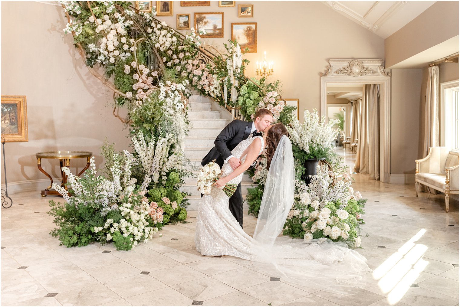 groom kisses bride dipping her backwards during wedding portraits inside Park Chateau 