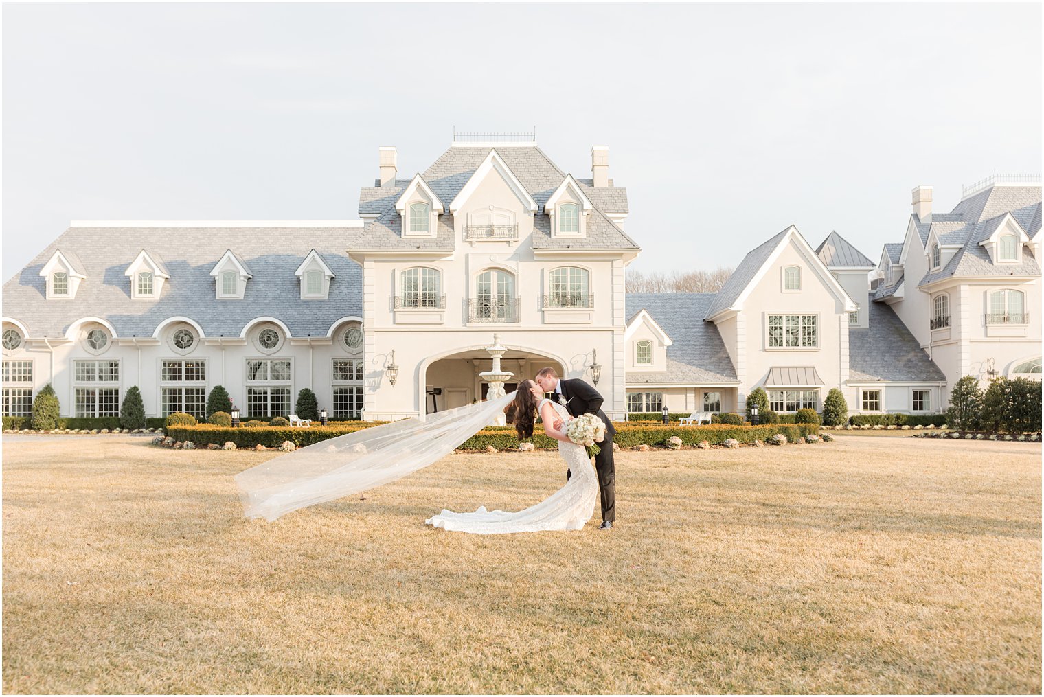 bride and groom kiss outside Park Chateau Estate 