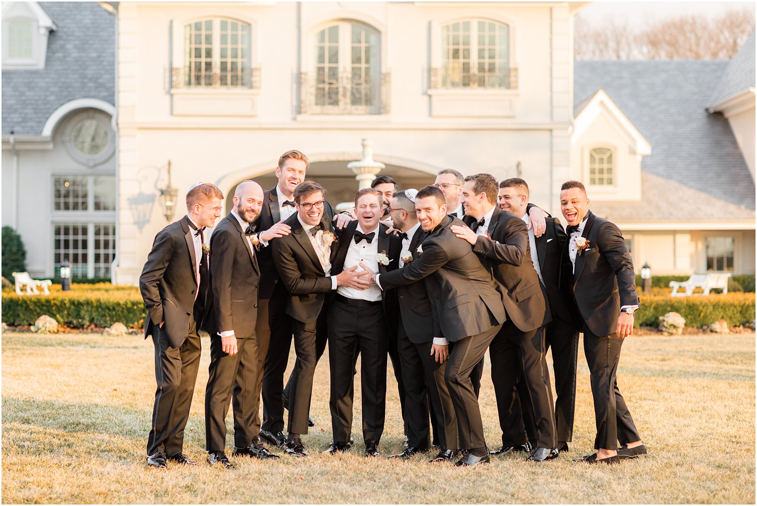 groomsmen hug groom before NJ wedding day 