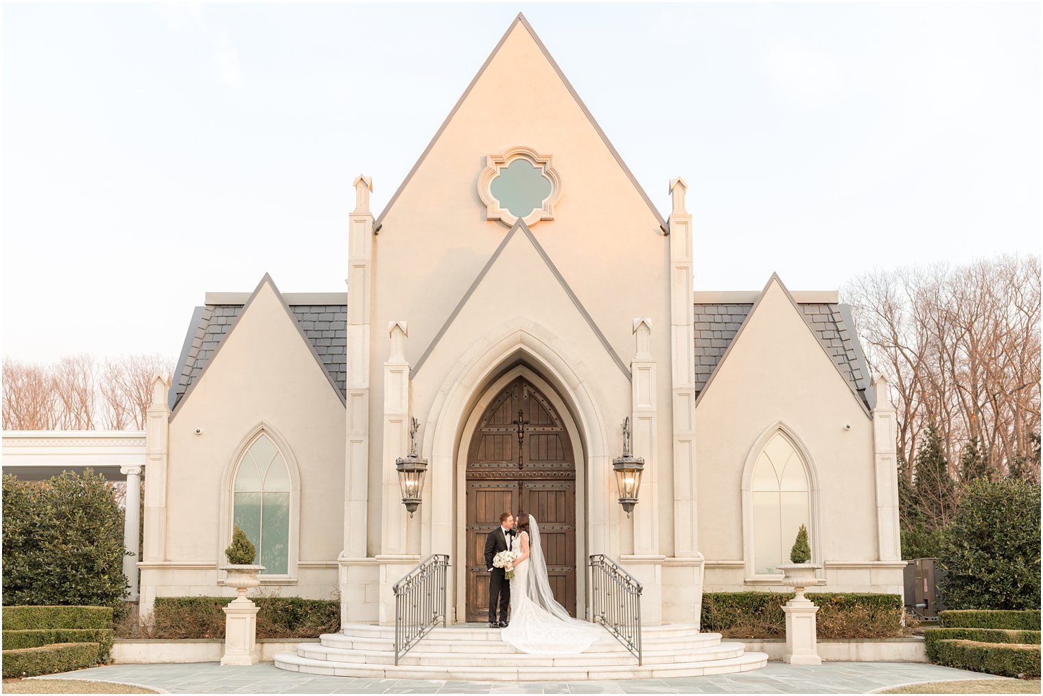 newlyweds stand on steps of chapel in East Brunswick NJ 