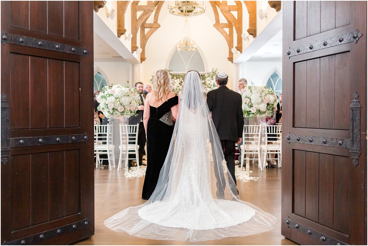 bride walks into wedding ceremony with parents for Jewish wedding ceremony 