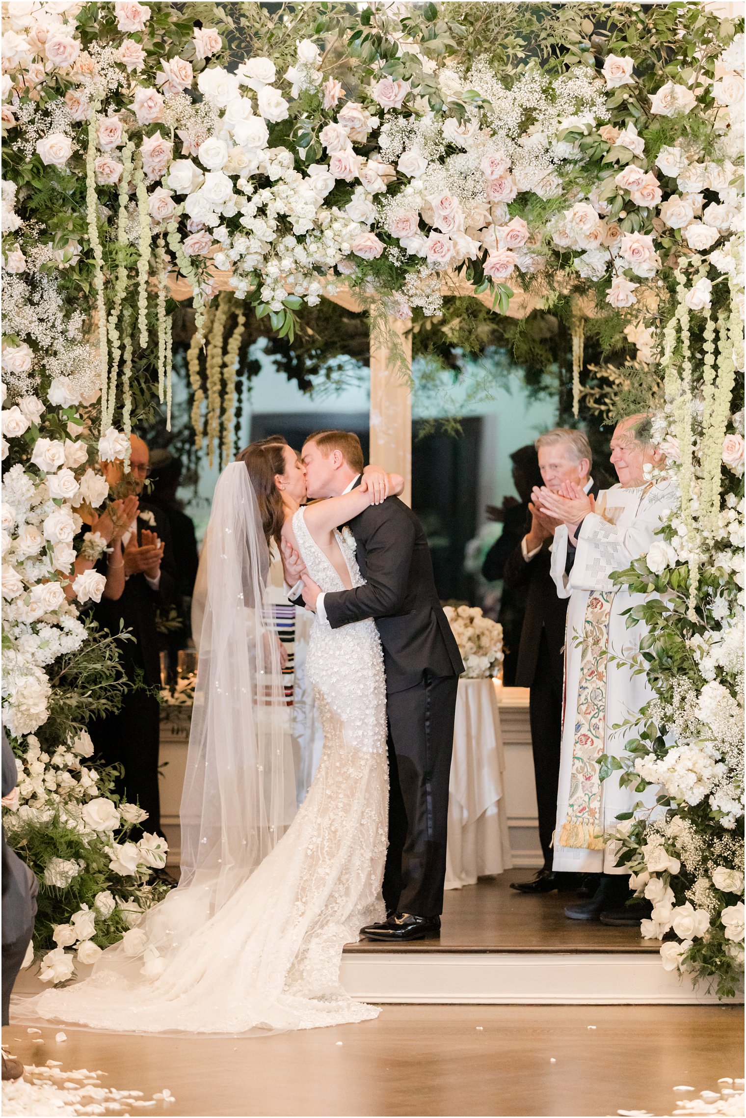 bride and groom kiss during Park Chateau winter wedding ceremony 