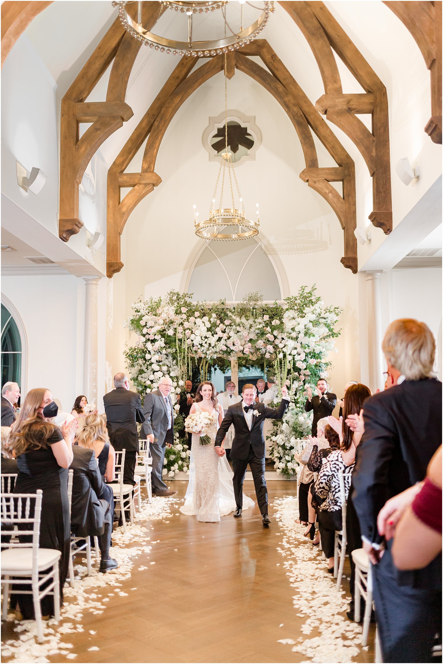 bride and groom walk down aisle after Park Chateau winter wedding ceremony 