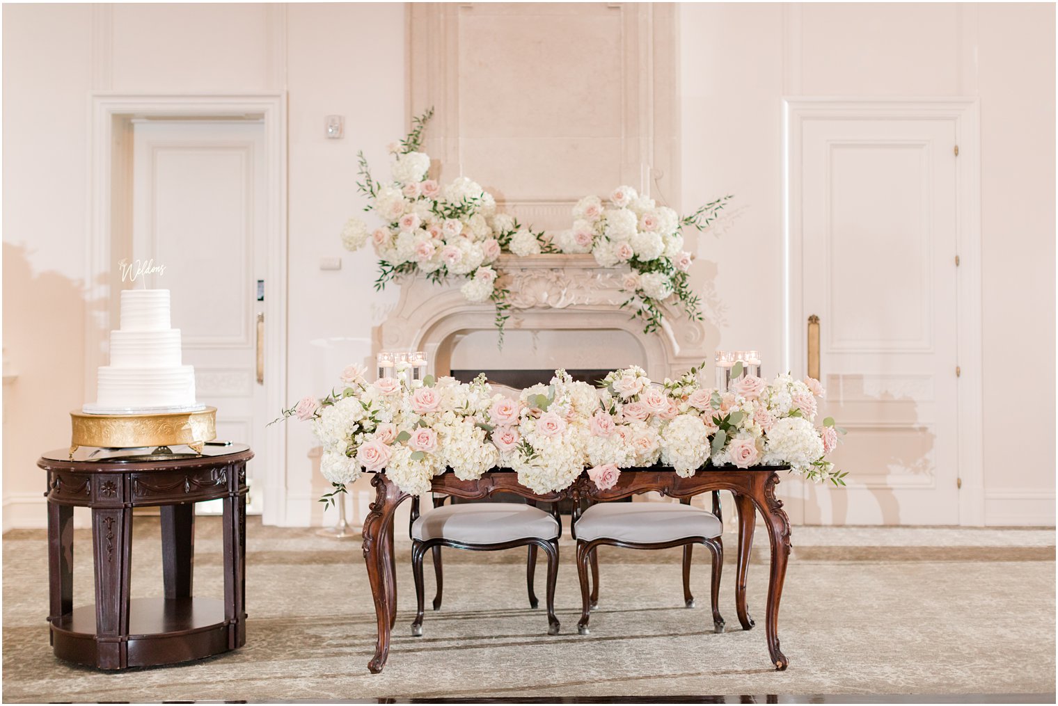 sweetheart table with large floral display at Park Chateau Estate with wedding cake 