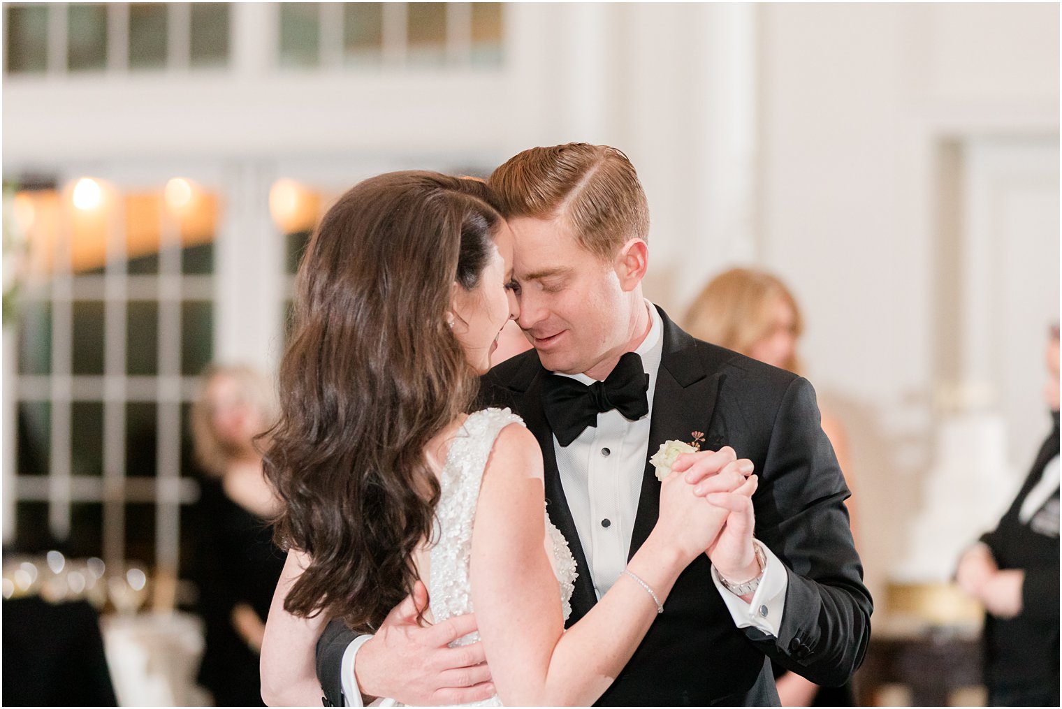 groom leans head into bride's forehead during dance at East Brunswick NJ wedding reception 