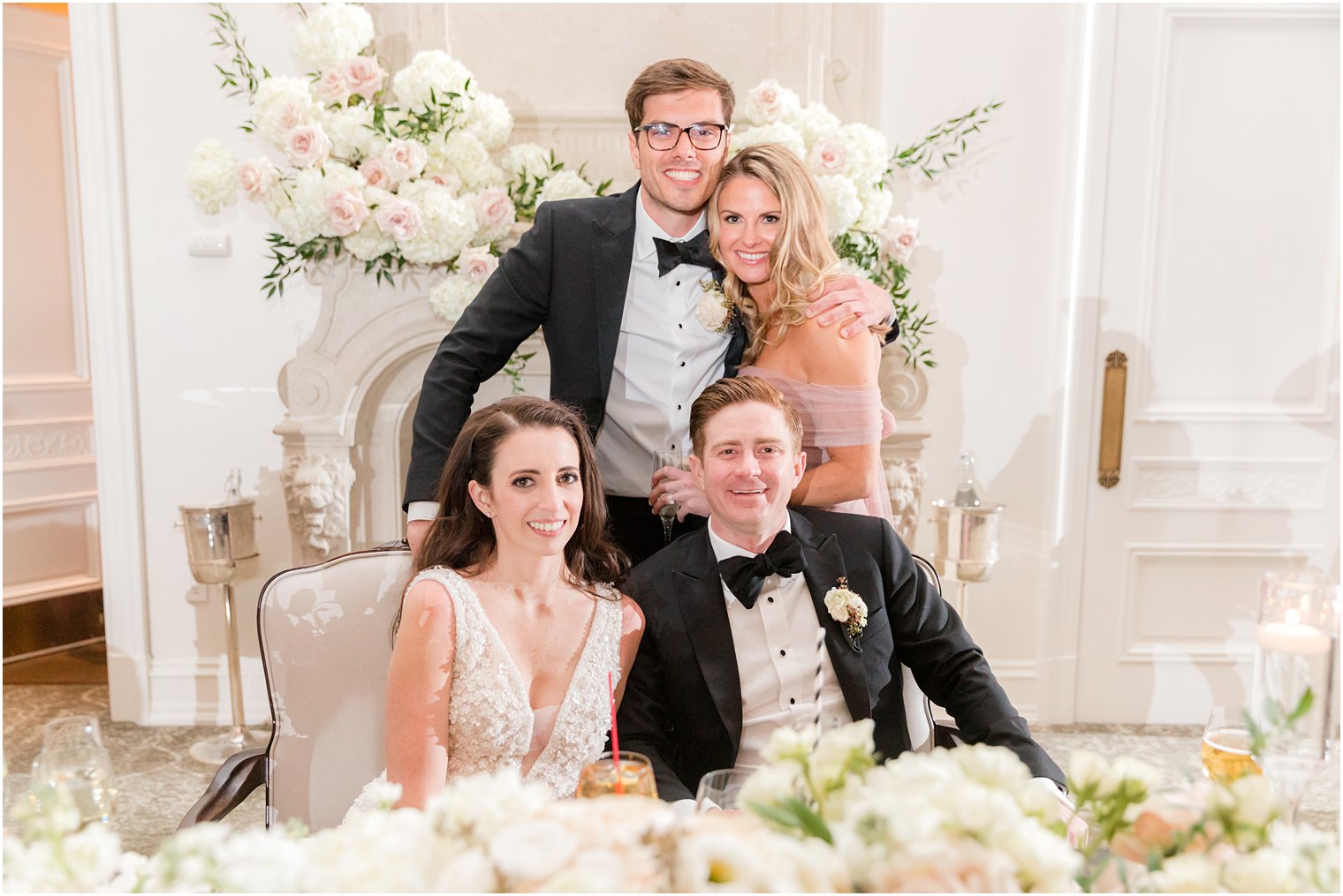 bride and groom stand with maid of honor and best man 