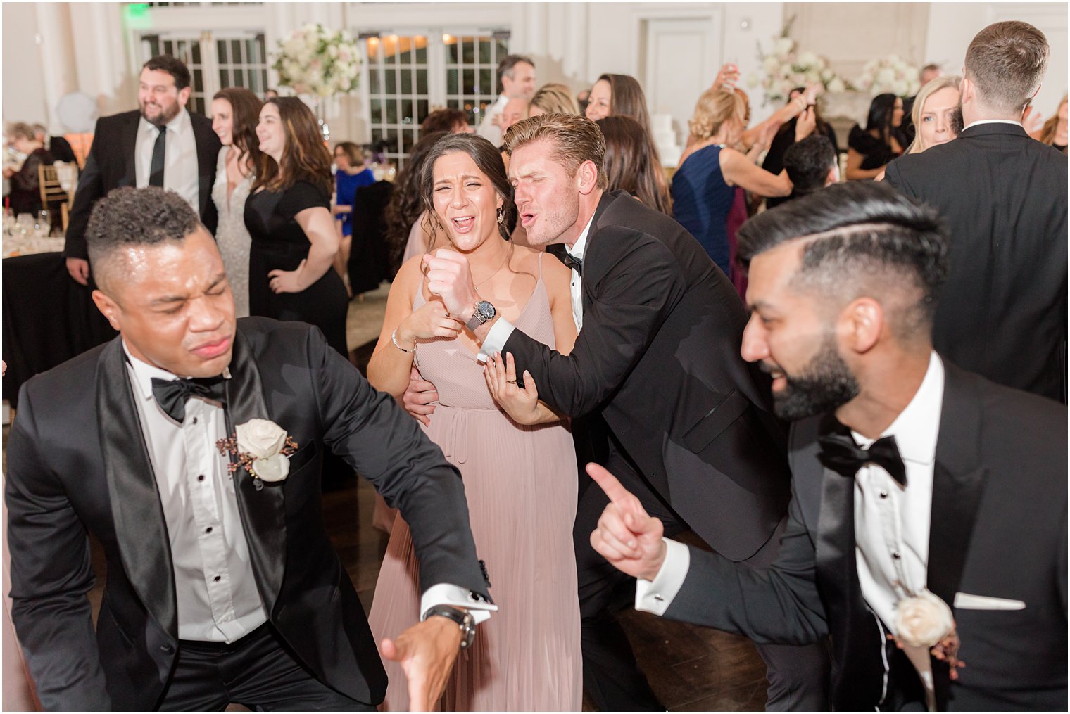 groom dances with bridesmaids during East Brunswick NJ wedding reception 