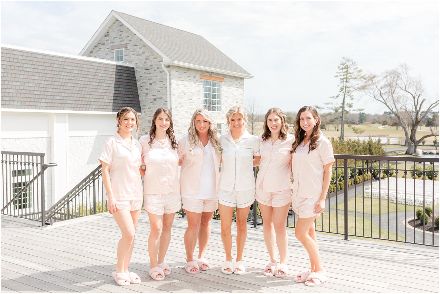 group photo of bridesmaids in pink pajamas at Renault Winery in Egg Harbor Twp NJ