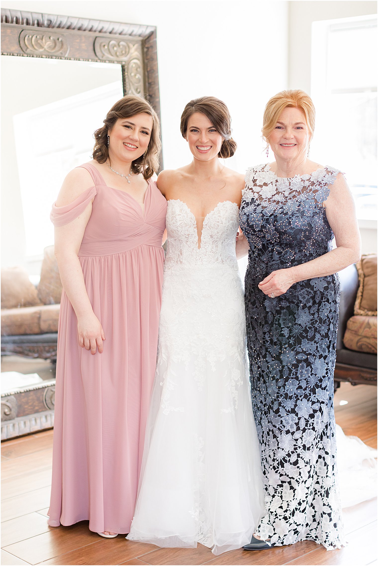 bride poses with mom and sister