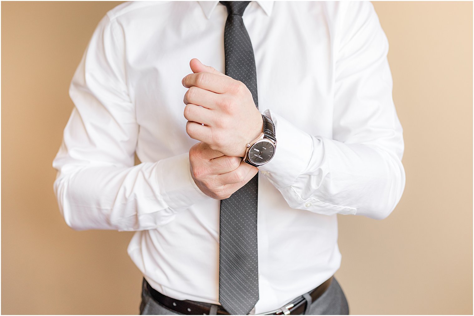 groom adjusts watch wristband