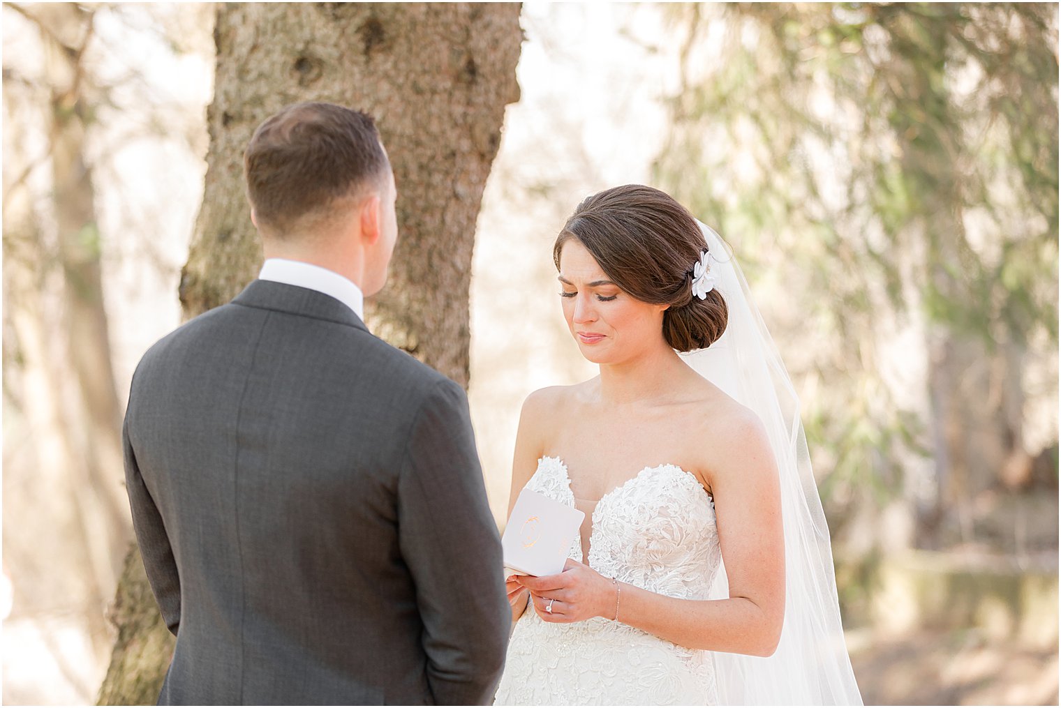 bride reads to groom during first look