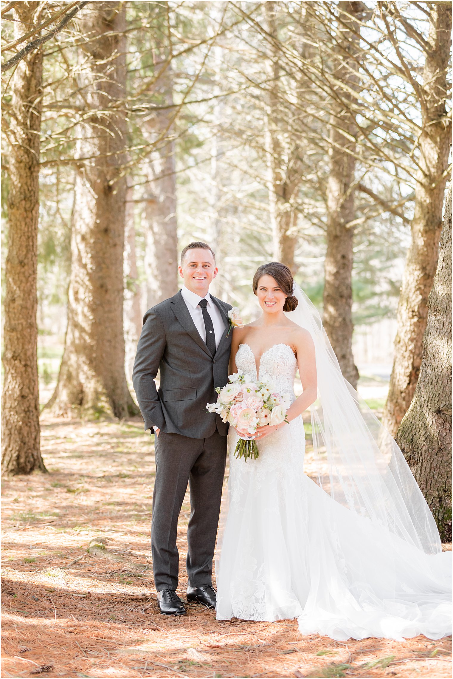 newlyweds pose in woods at The Refinery at Perona Farms