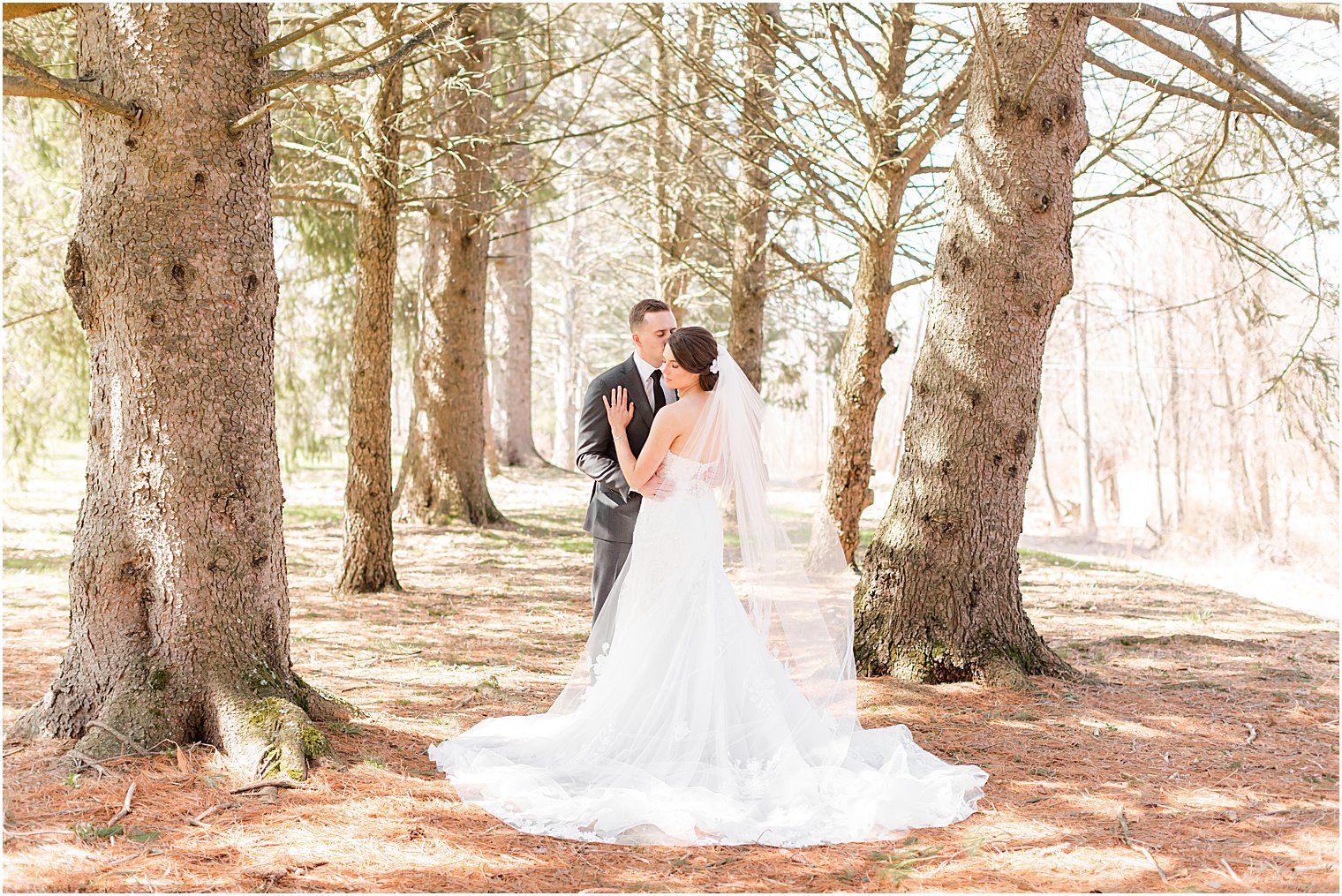 couple hugs in woods during NJ wedding portraits 