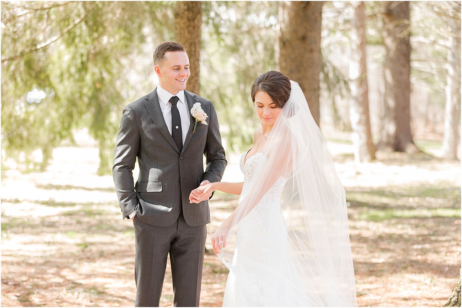 groom looks at bride while she looks over her shoulder