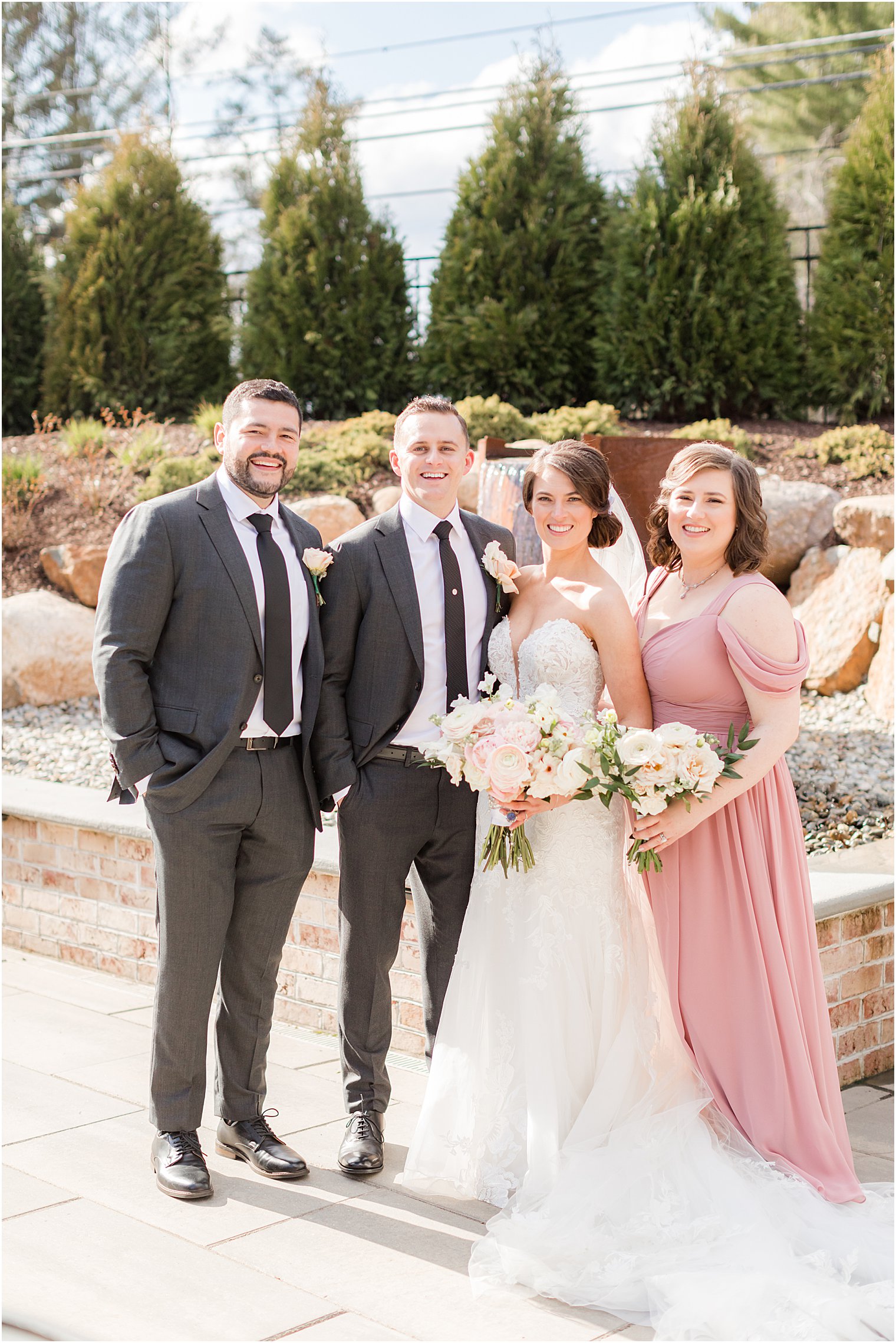 newlyweds pose with bridal party at The Refinery at Perona Farms