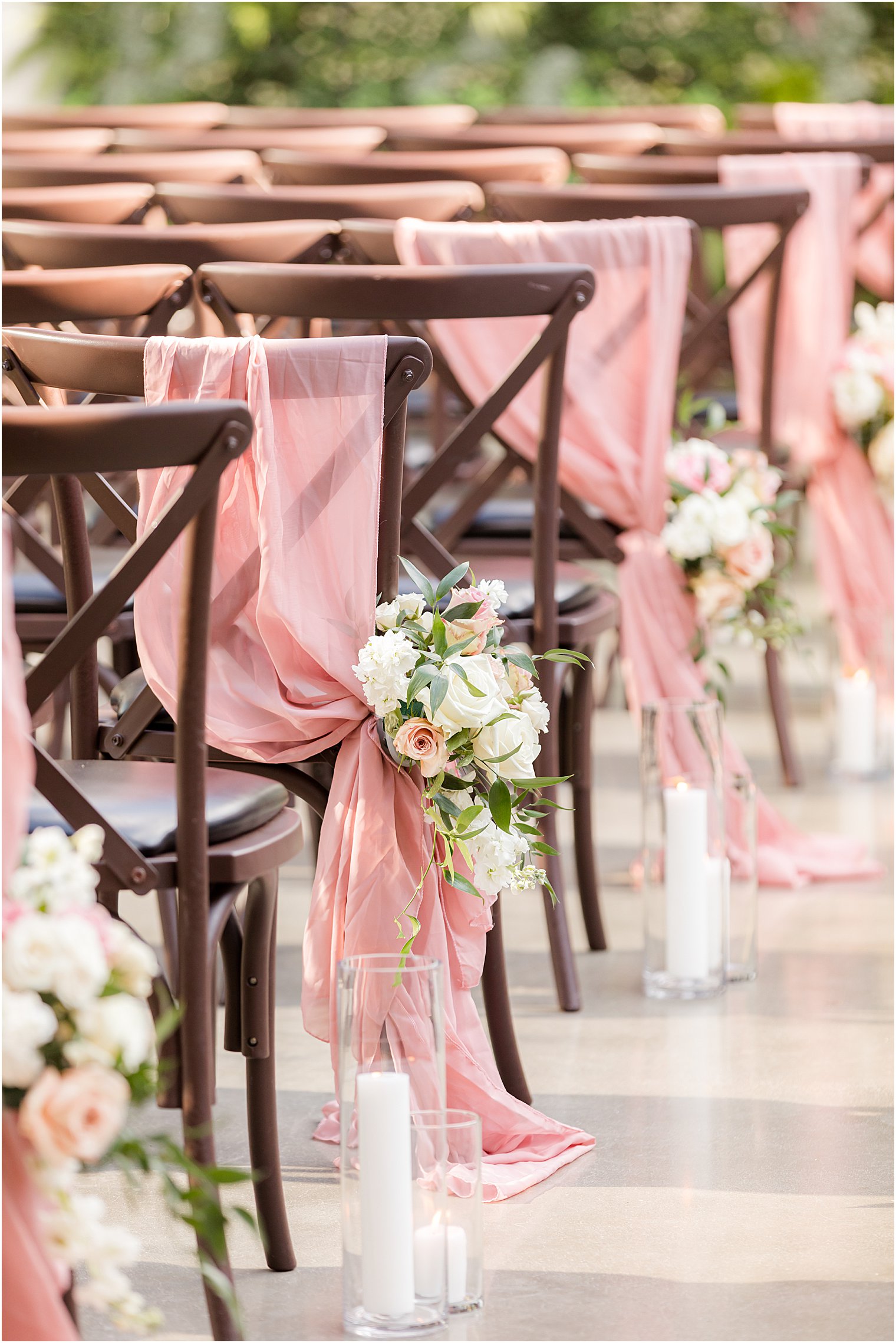 brown chairs with pink fabric draped 