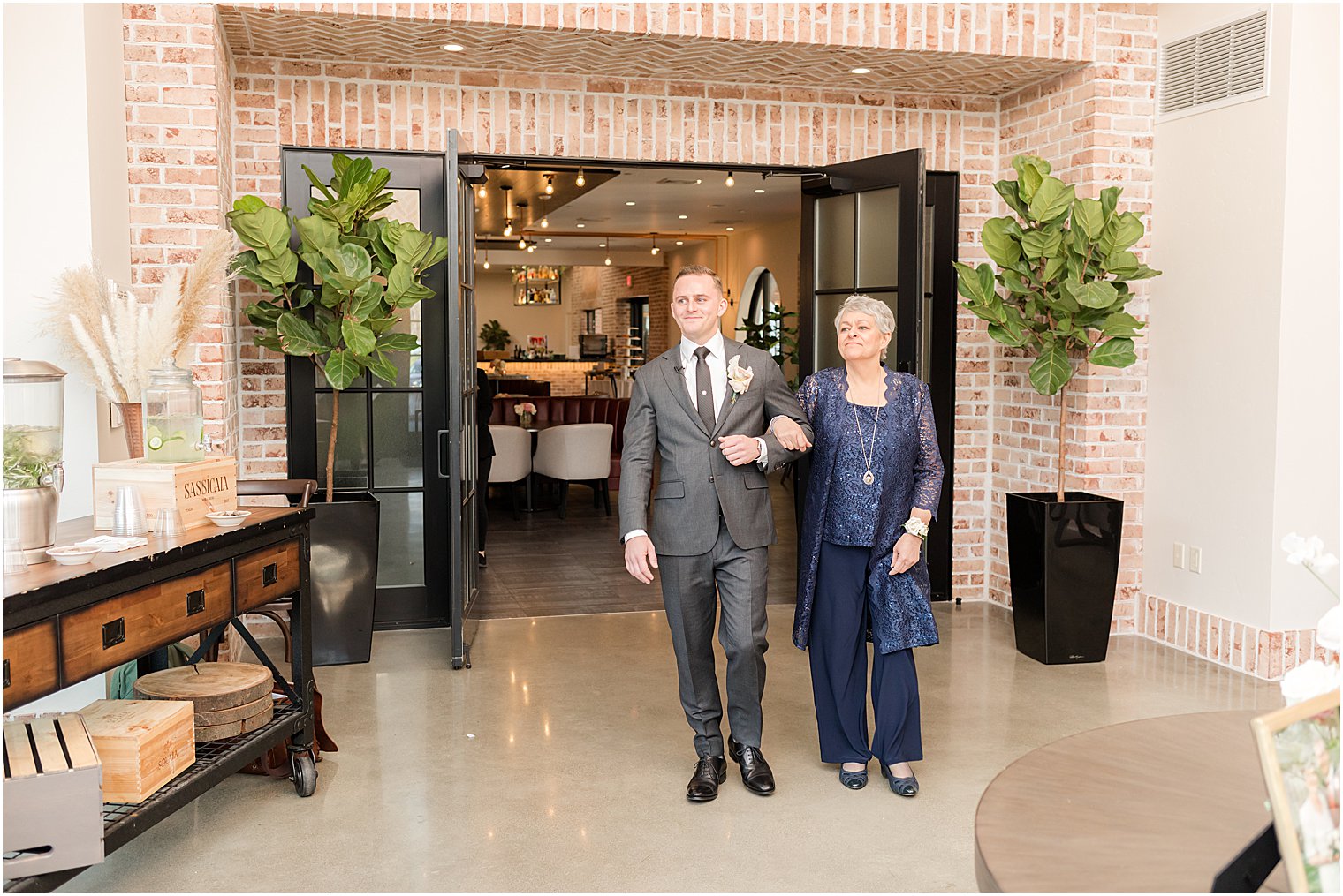 groom walks into ceremony with mother