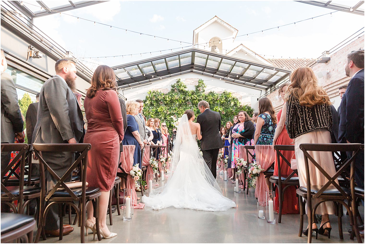 bride and dad walk up aisle at The Refinery at Perona Farms