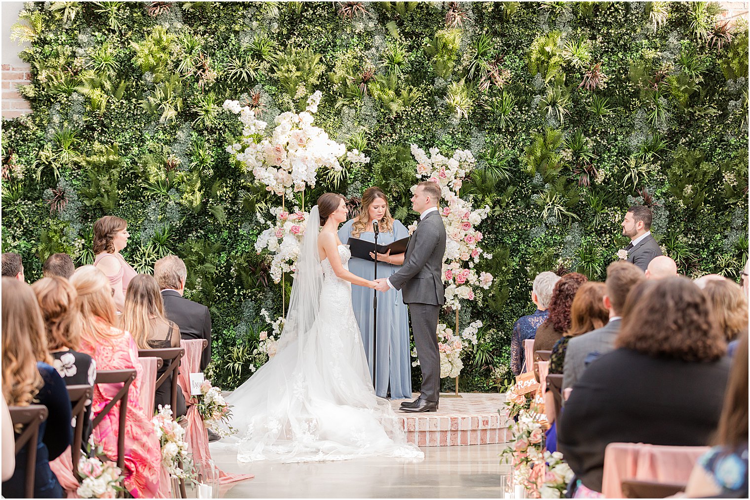 couple exchanges vows during outdoor wedding ceremony in courtyard