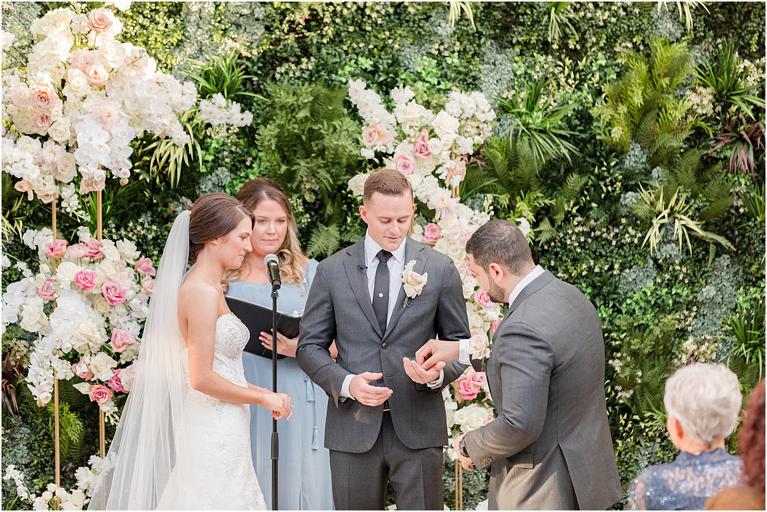 best man gives groom rings during ceremony 