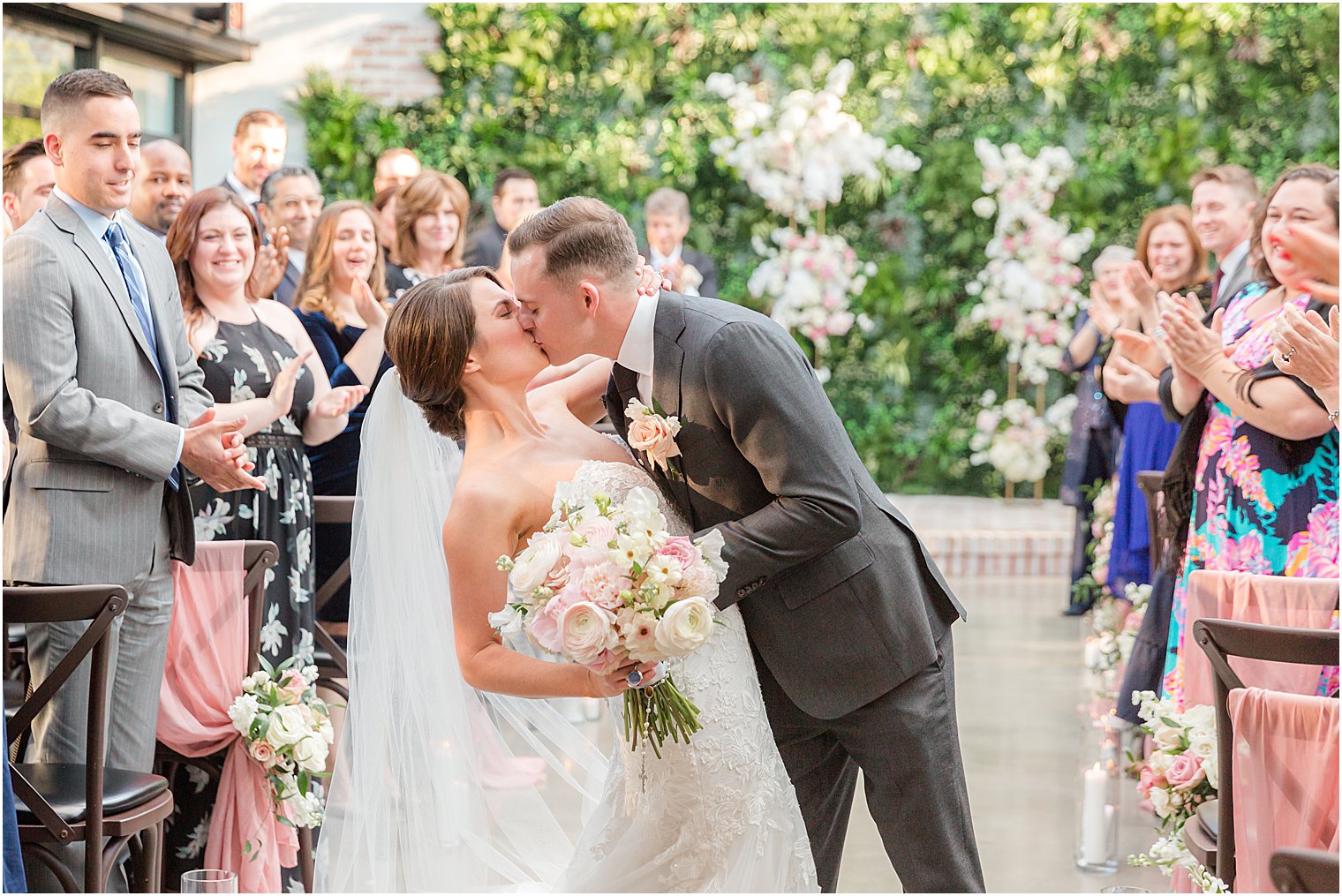 newlyweds kiss walking up aisle