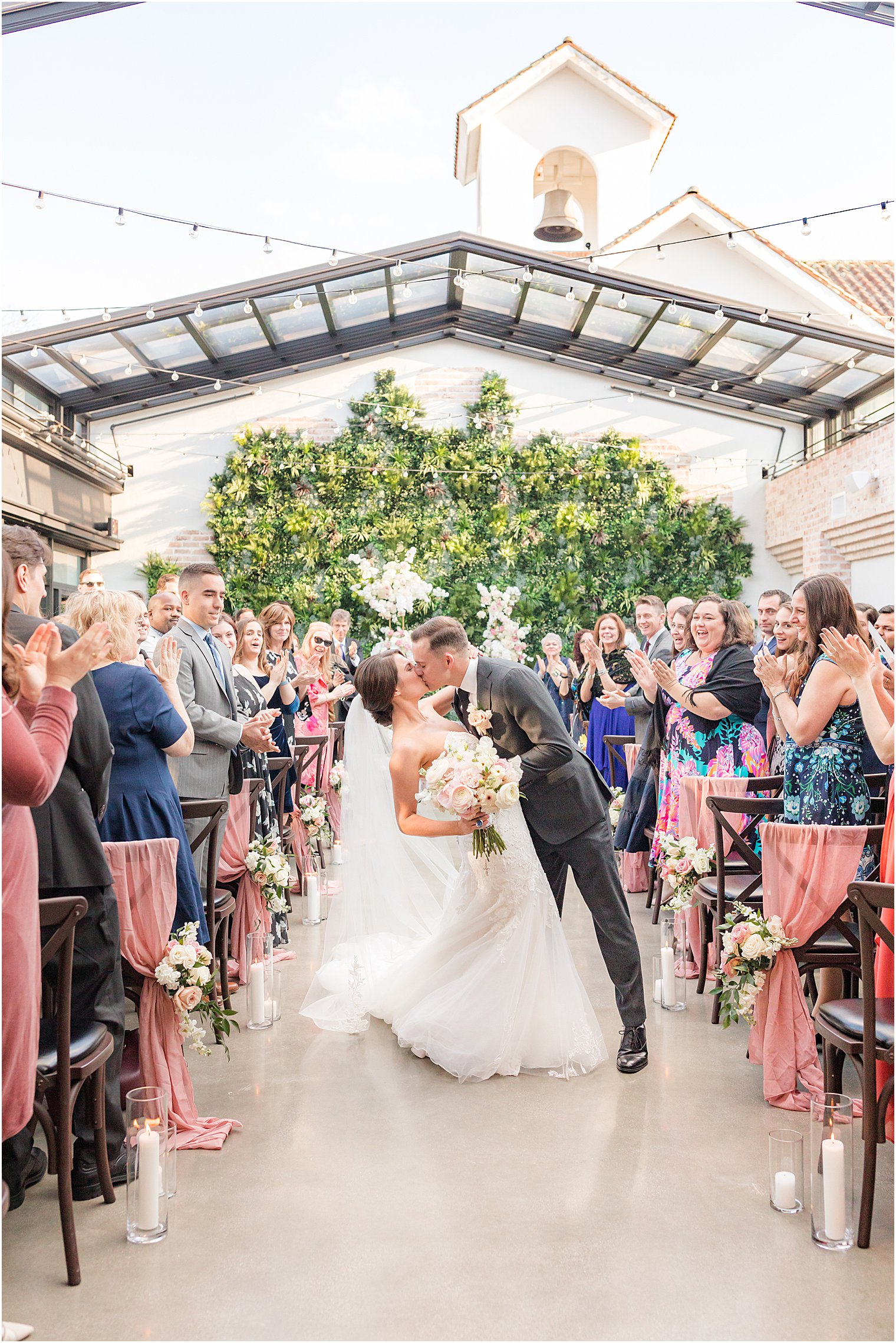 bride and groom kiss up aisle after wedding ceremony